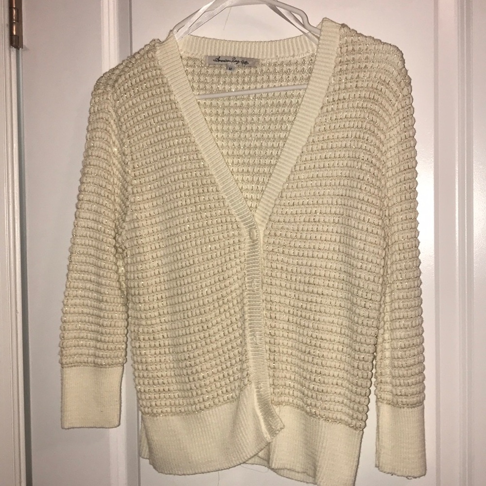 Cream colored cardigan with gold detailing